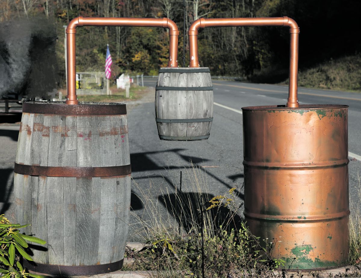 Depiction of a still (short for distillation apparatus) part of the roadside advertising emphasizing a backwoods theme at a gift shop in Maggie Valley, in the Great Smoky Mountain Range of far-western N.C. Simple stills are often part of illegal “moonshine” whiskey-making operations “back in the hills.” Carol M. Highsmith, Library of Congress.