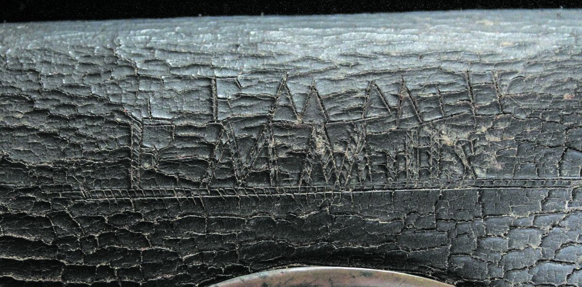 F.M. Mills has twice carved his name into the face of the box’s outer flap.