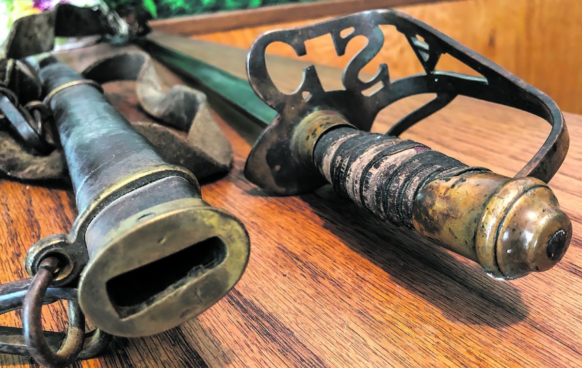 Grip is made from spirally cut wood with leather cover and wire wrap. Much of the leather has chipped away due to the dry environment where it was stored the past 150 years in attic or barn.