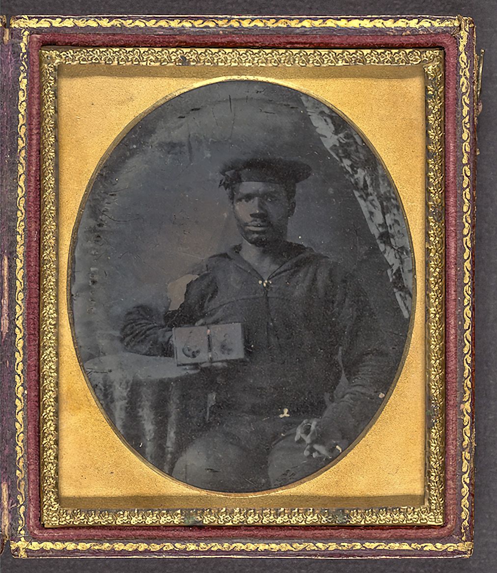 Union sailor holding a cased set of two photographs.