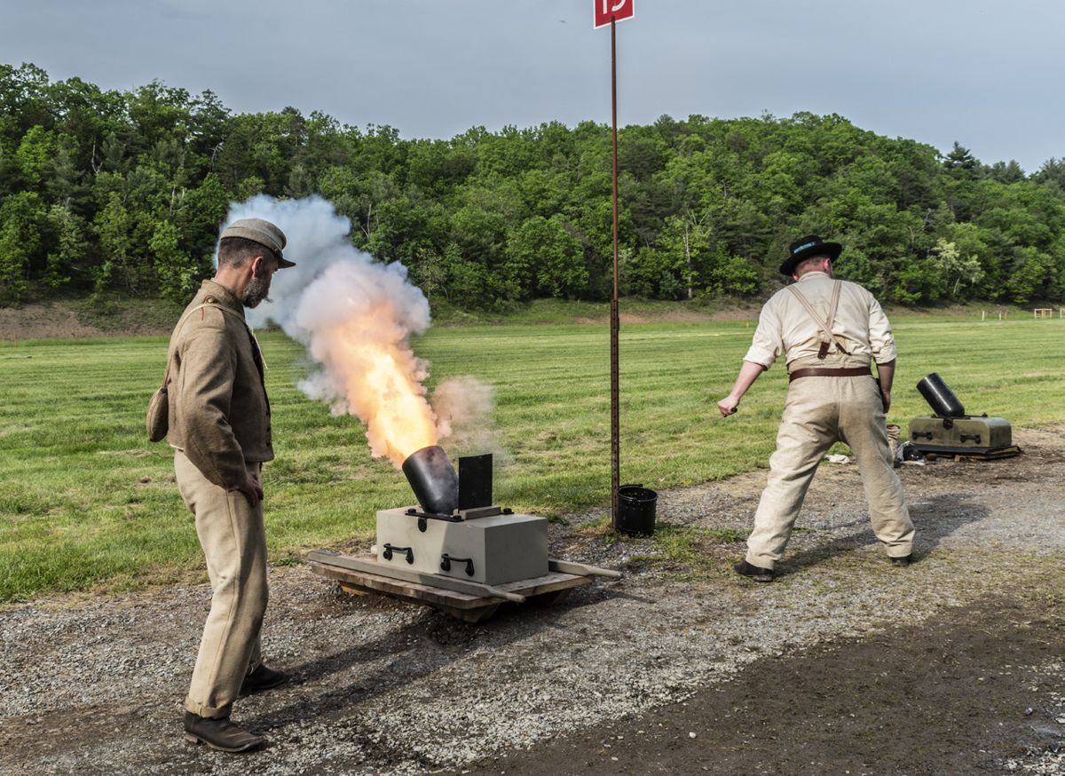 A crewman with Hardaway's Alabama Battery watches his teammate pull the lanyard to fire their mortar at a stake placed 100 yards down range. Despite the intense heat, this unit prides itself on historical accuracy and remained in full uniform for the match. (Ericka Hoffmann Curley) Hardaway’s Alabama Battery fires their Tredegar 12-pounder field howitzer at the bullseye target at 100 yards.