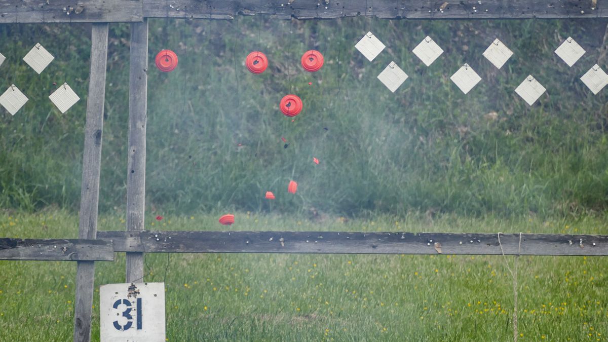 Hanging clay pigeons placed at 25 yards from the firing line shatter as they are hit by revolver fire. (Lis Cole)
