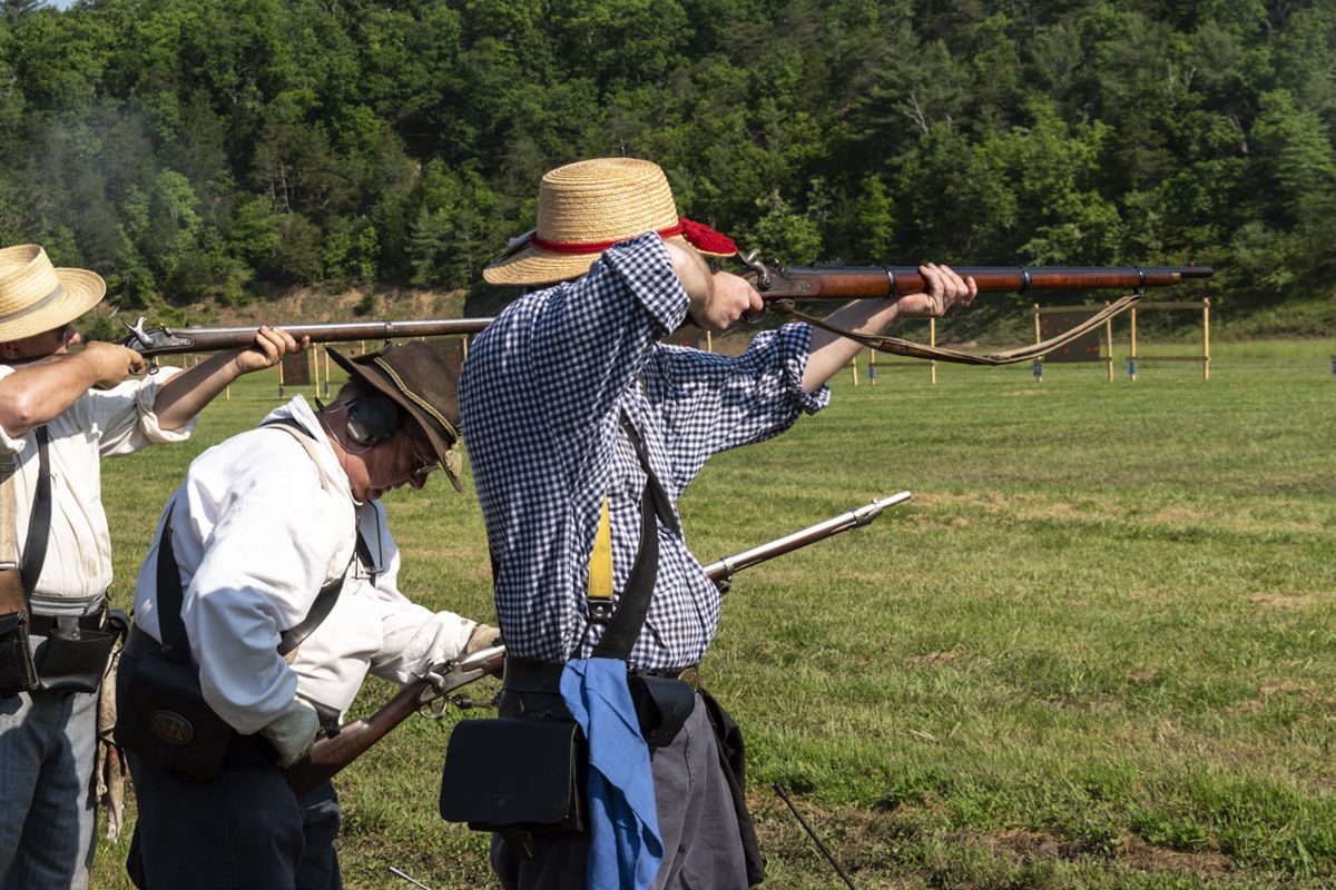 Members of the 1st Regiment Virginia Volunteers fire at the targets on the “pigeon board,” a signature event in the musket match. Eight-person teams compete to clear the board in the least amount of time. (Ericka
