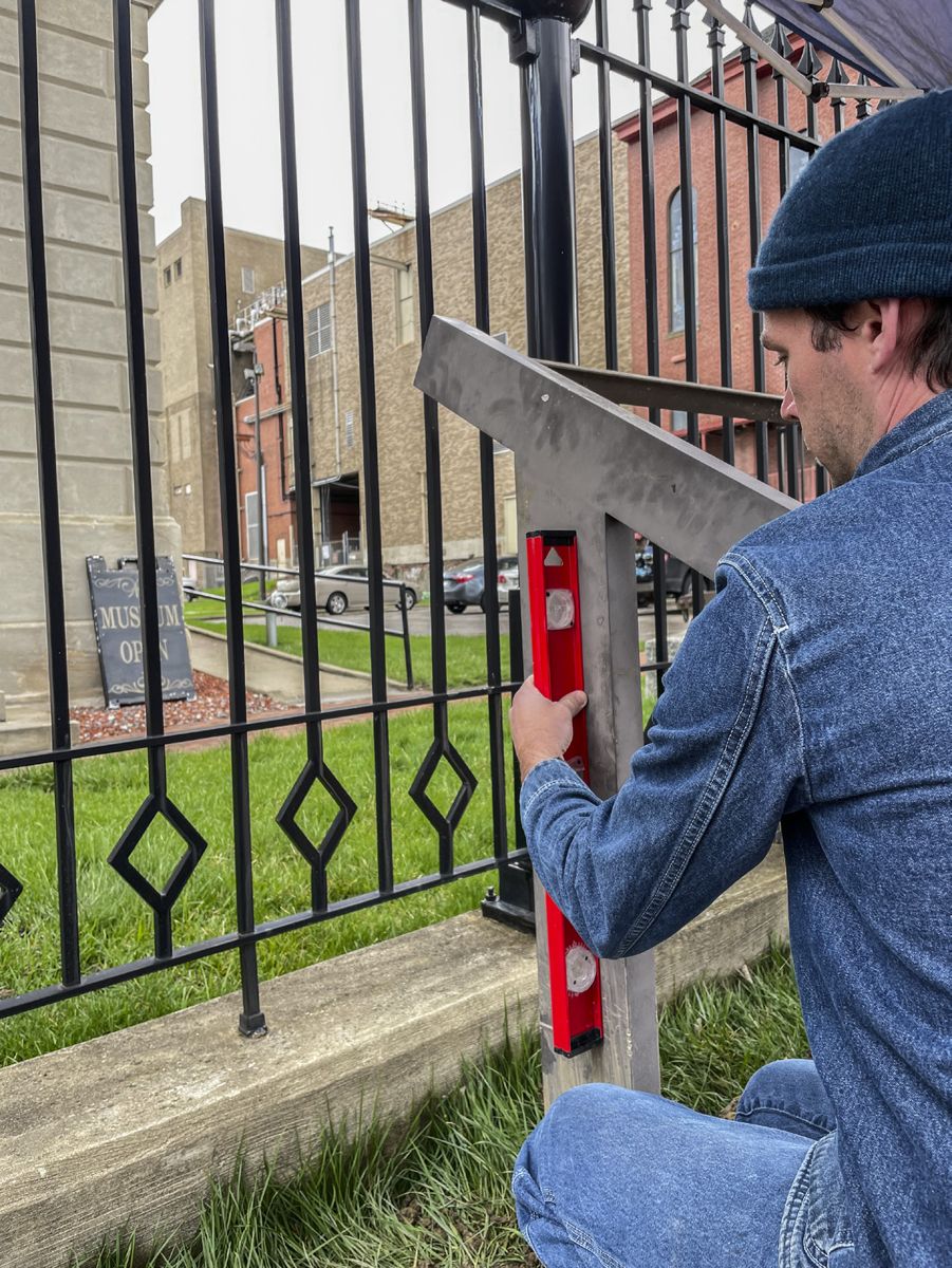 Chris Brown, Assistant Director of Civil War Trails, levels the new sign pedestal now installed in a more handicapped accessible location in front of Independence Hall. (Civil War Trails, Inc.)