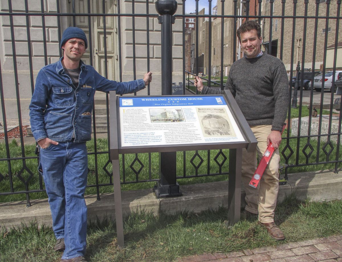 Chris Brown (left) and Drew Gruber (right) pose with the new sign at Independence Hall. That same week they updated over a dozen other signs throughout Virginia, West Virginia, and Maryland. (Civil War Trails, Inc.)