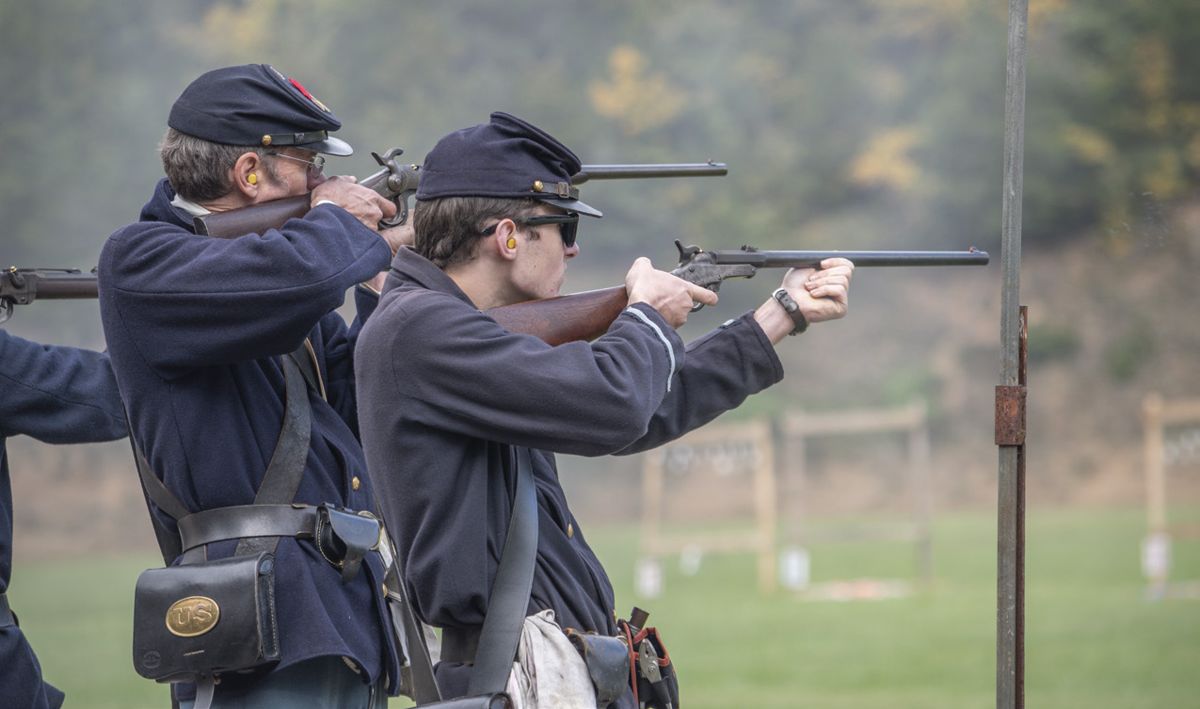 A member of the 15th Regiment New Jersey Volunteer Infantry aim their Maynard Carbines, which are highly sought-after by skirmishers; and many used in this sport are original guns. Sharps, Smith, and Burnside carbines are also favorites among carbine shooters.