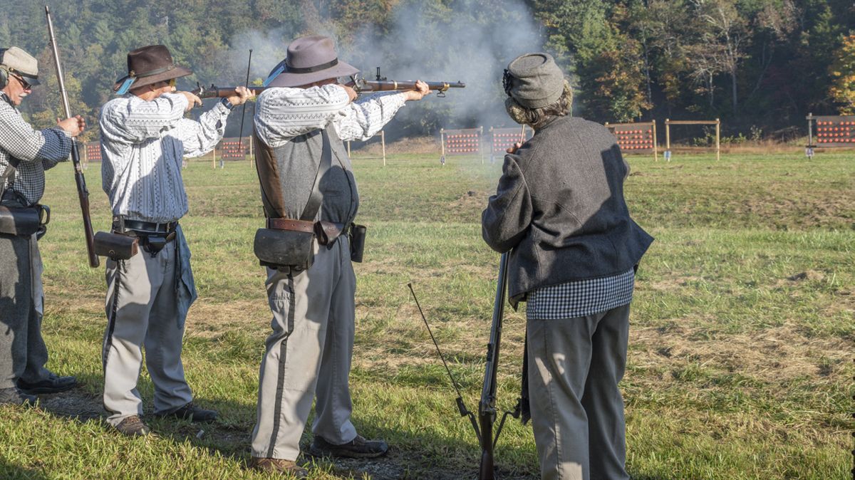 Many generations of skirmishers have grown up in this sport. In this photo, three members of the Rogers family of the Iredell Blues take aim and fire. (Ericka Curley)