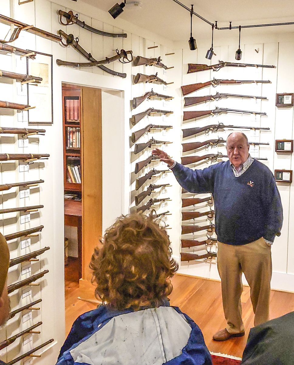 Charles McDaniel speaks to the group about his weapons collection.