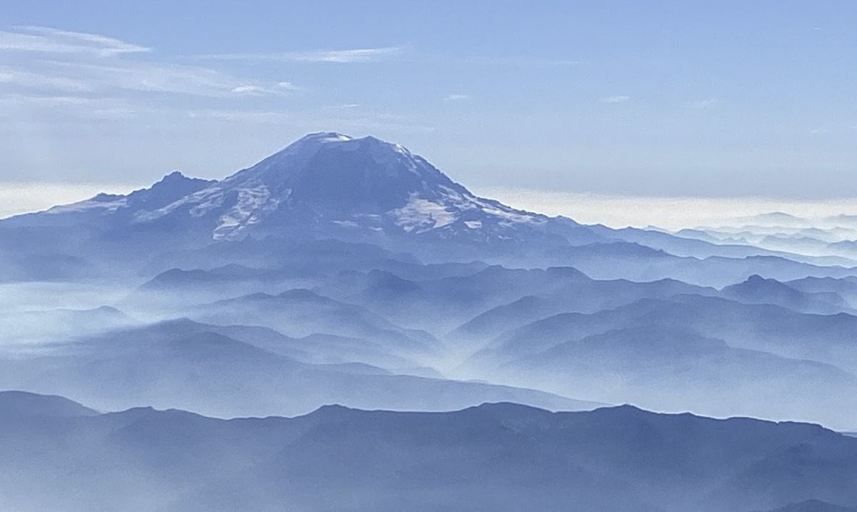 Mount Rainier rises above the smoke of western wild fires.