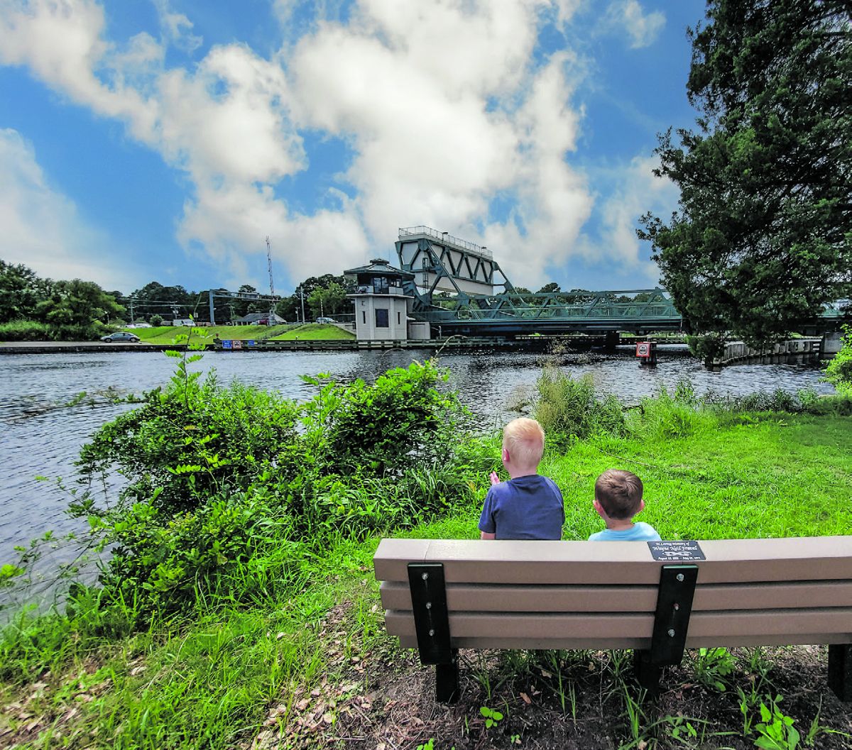 Children peer out at the drawbridge over the Elizabeth River at the Great Bridge Battlefield. Photo by Melissa Sadler.