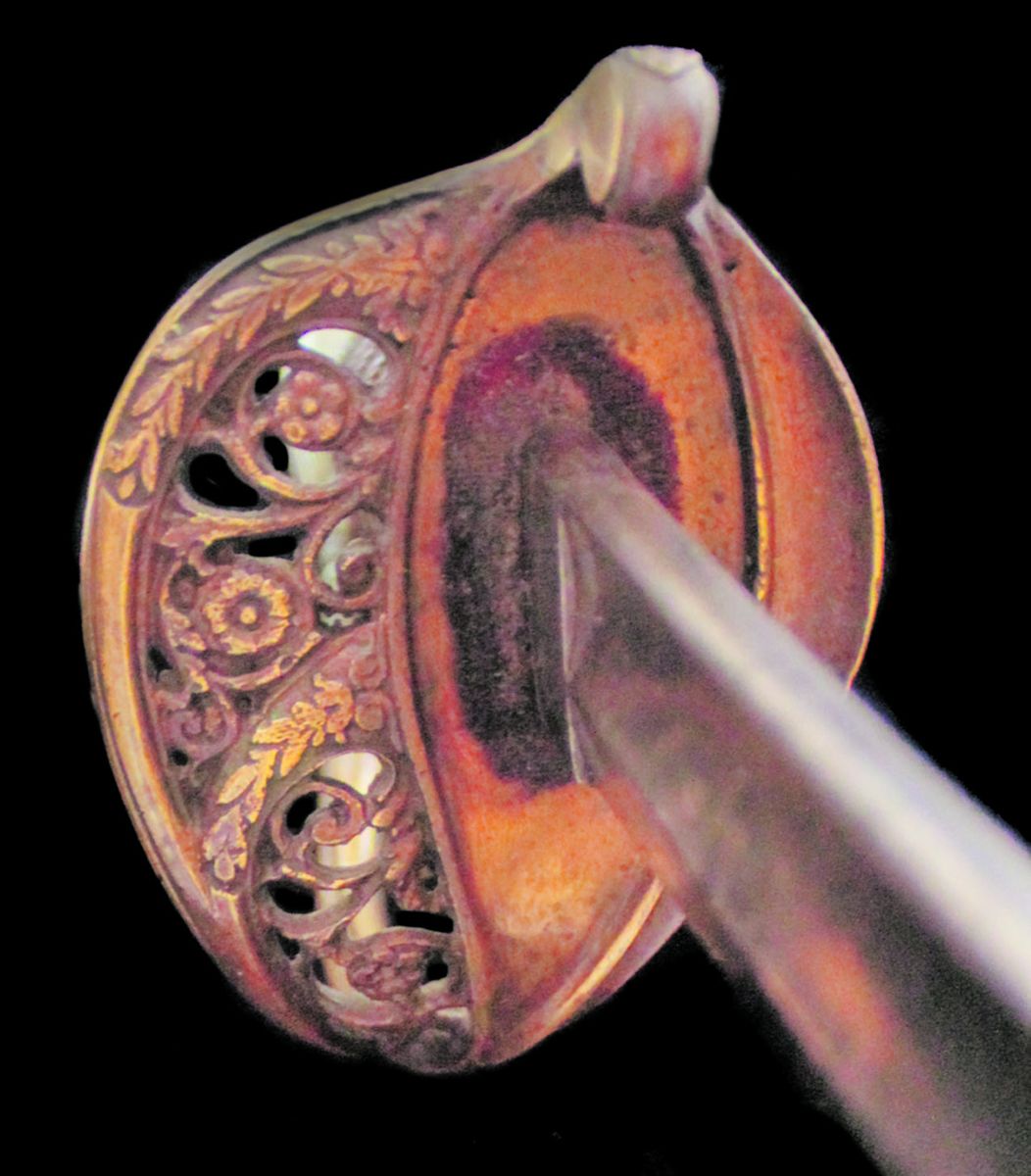The foot officer’s sword still retains its red cloth throat washer.