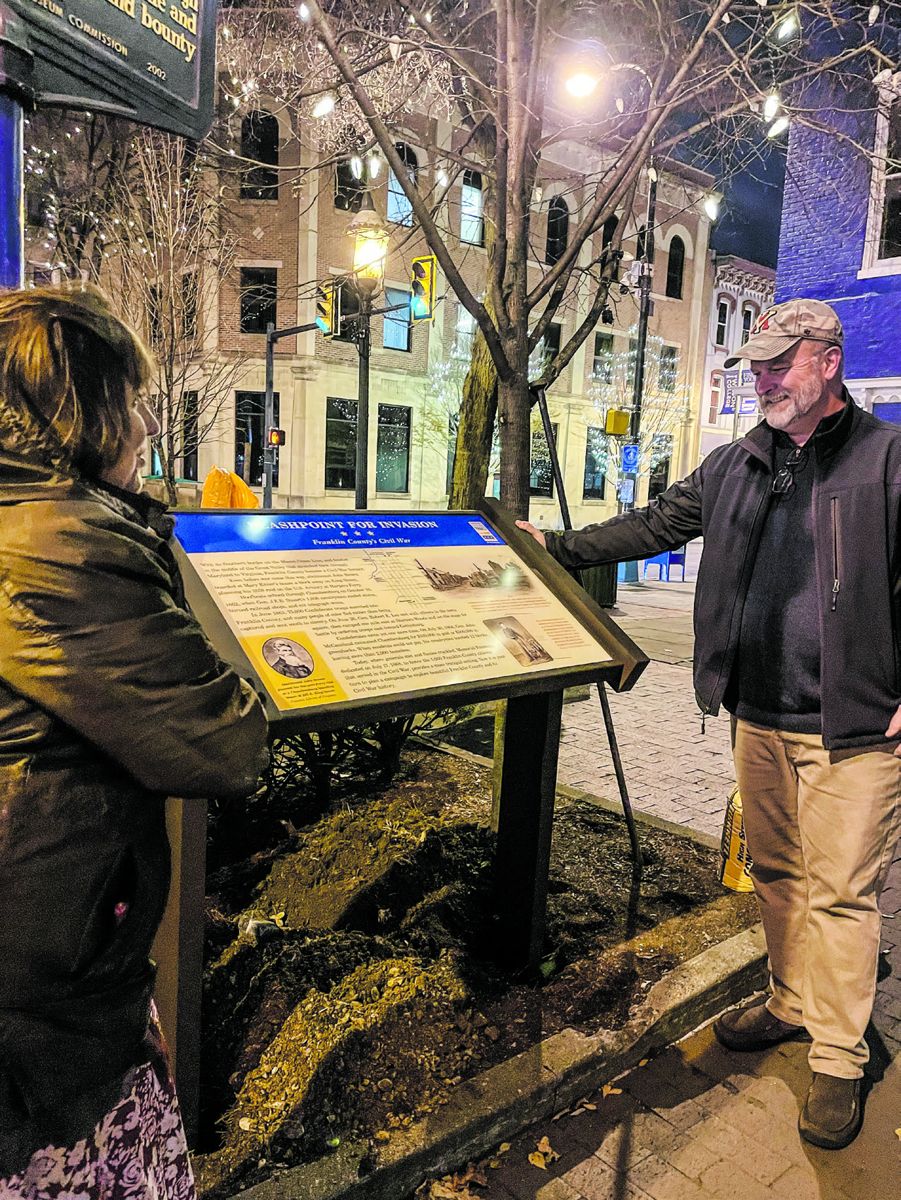 Janet Pollard, Tourism Director for Franklin County and Guy Shaul, Community and Economic Development Specialist for the Borough (right) place the new sign at 15 S. Main Street. The purpose of this first site is to act as a collector for visitors interested in the region’s Civil War history. Courtesy Civil War Trails, Inc.