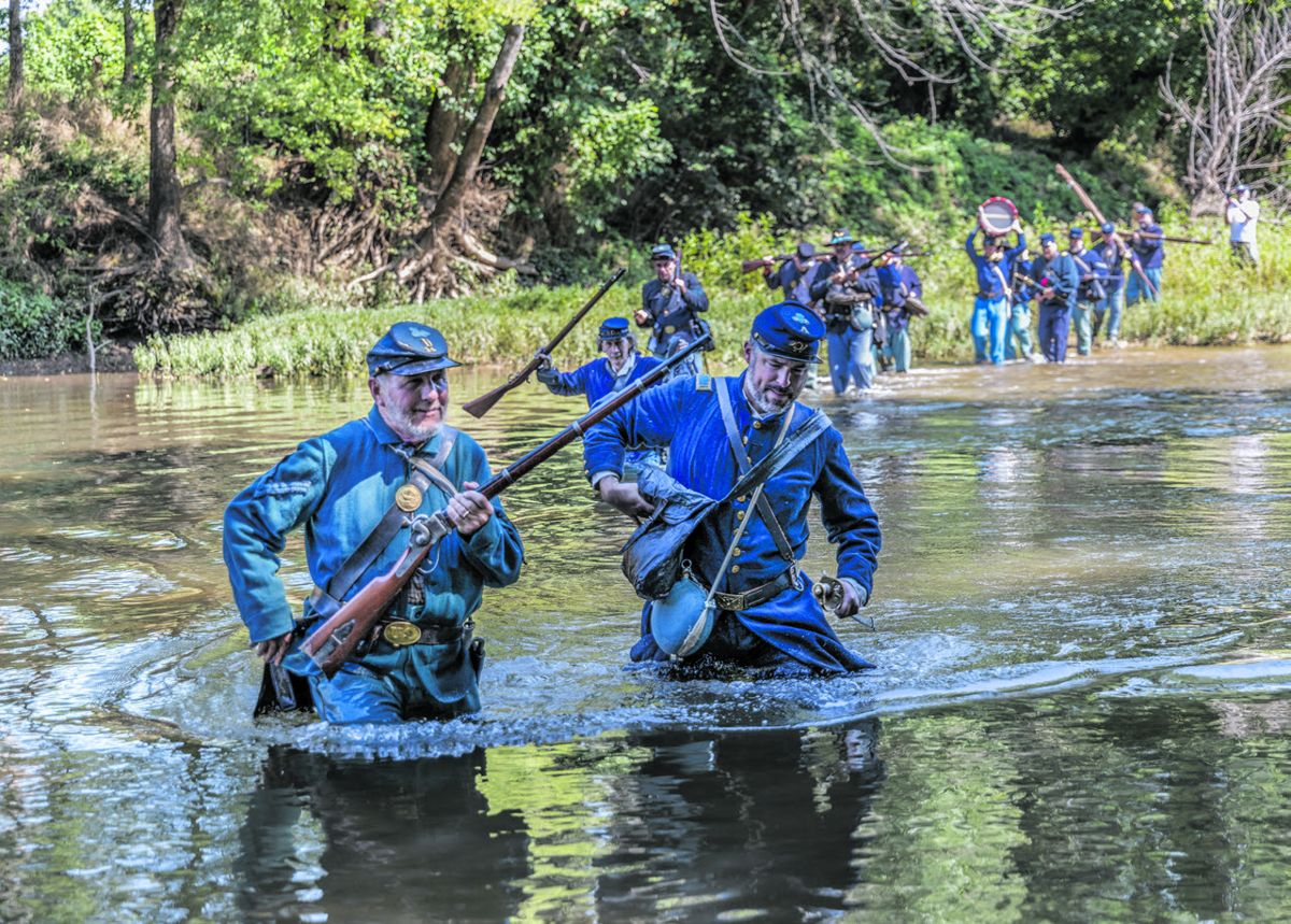 Members of the 14th and 8th Conn. cross the waist deep water of Morton’s Ford on the Rapidan River. Left-right: In front are Frank Niederwerfer and Kierran Broatch (portraying his great great grandfather Captain John Broatch, 14th CVI).