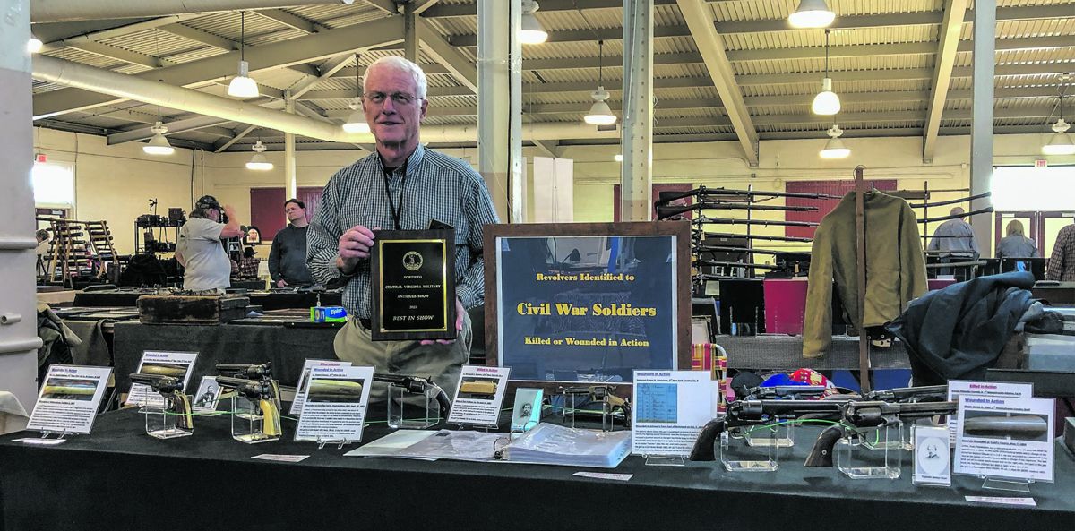 Bill Thompson showing his Best of Show plaque for his 'Revolvers Identified to Civil War Soldiers Killed or Wounded in Action' display.
