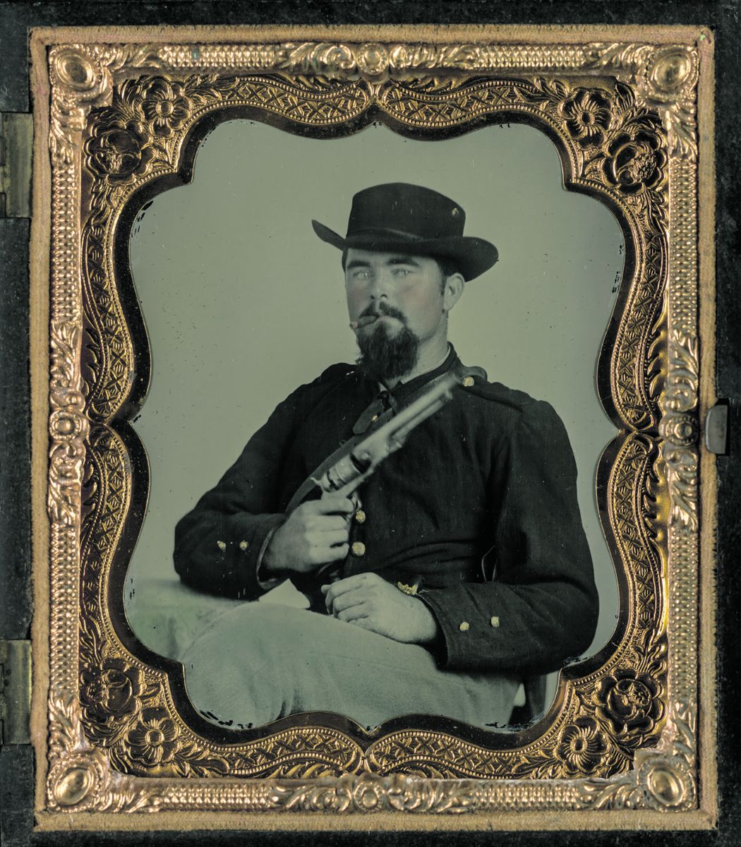 Private William B. Todd of Company E, 9th Virginia Cavalry Regiment with Colt Model 1860 .44 caliber Army revolver. He is wearing a jacket with epaulets and left chest exterior pocket and smoking a cigar. Liljenquist Family Collection of Civil War Photographs. (Library of Congress)