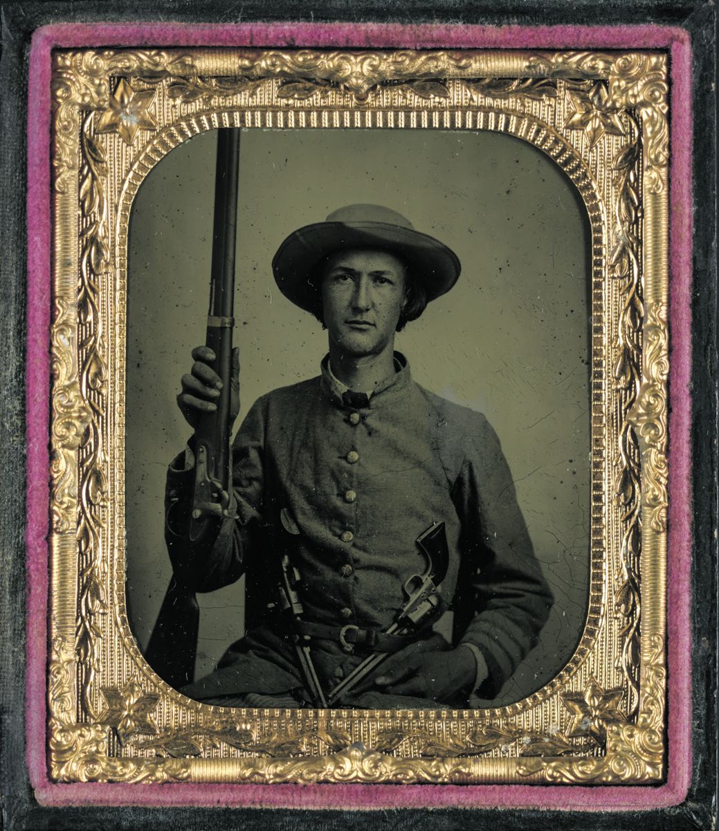 Unidentified soldier in Confederate frock coat with Model 1842 musket and two Colt revolvers. Liljenquist Family Collection of Civil War Photographs. (Library of Congress)