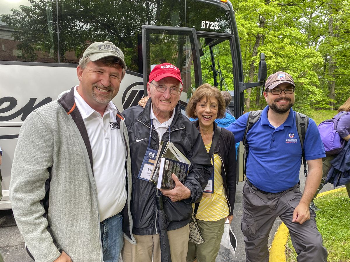 Chris Mackowski (left) and Kris White (right) enjoyed the company of legendary football coach Vince Dooley and his wife, Barbara, on a bus tour at the ABT conference.