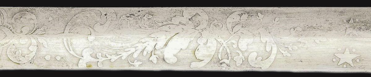 Two smaller stars floating above an intricate foliate pattern. Note the extremely delicate foliate styling.