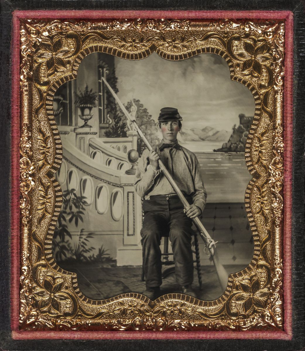 Union recruit in shirt sleeves wearing forage cap with .69 caliber percussion conversion musket with fixed bayonet posed in front of painted backdrop. Liljenquist Family collection (Library of Congress).
