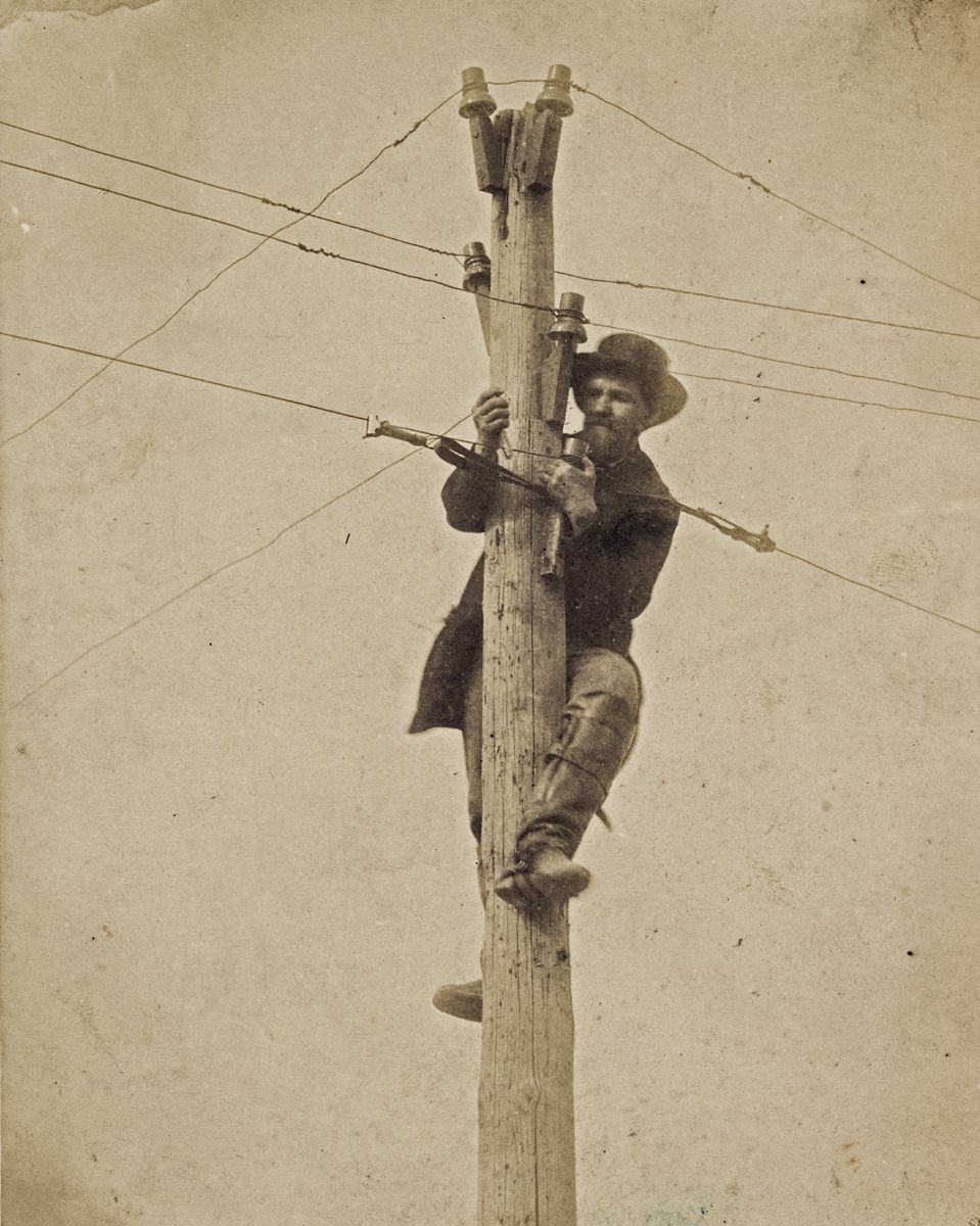 Worker repairing telegraph line. (Library of Congress)