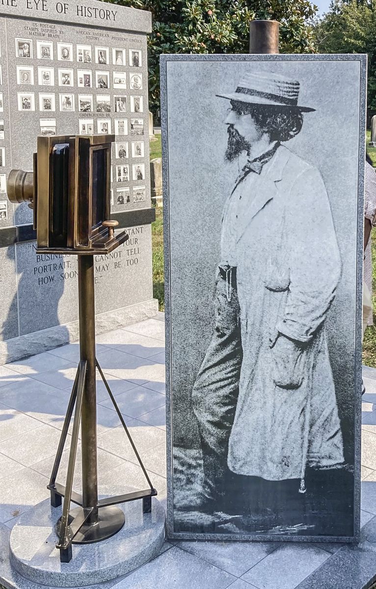 State-of-the art, life size, fired porcelain photograph of Mathew Brady. The original portrait of Brady wearing a duster and straw hat, was taken shortly after his return from Bull Run, July 1861. His likeness is positioned next to a bronze rendering of a large format, circa 1860s wet-plate view camera. (All photos by Jack Krainik)