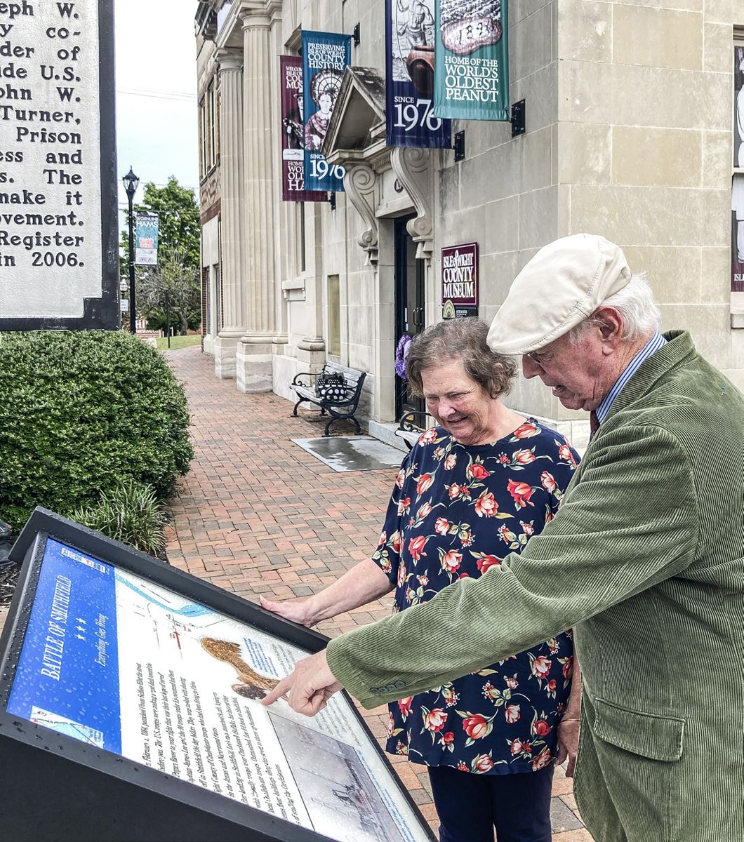 Albert Burckard of Carrollton and Dee Campbell of Smithfield became the first visitors to the new sign only minutes after it was installed. (Photo courtesy of the Isle of Wight County Museum)