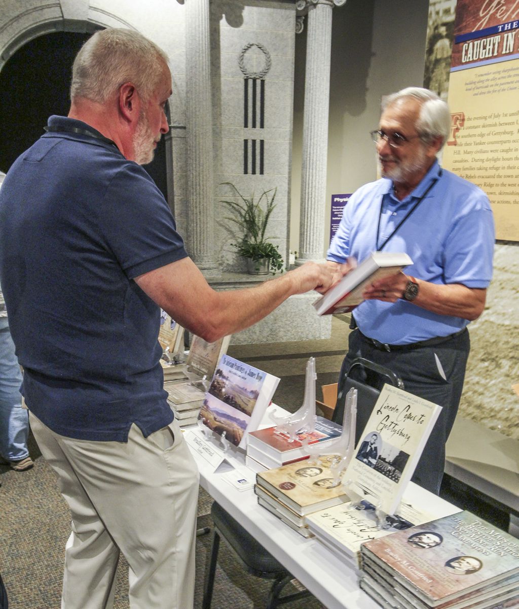 Brad Gottfried talks with a William Kennedy at the Heritage Center.