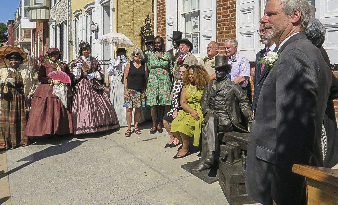 Living historians and politicians pose after ceremony.