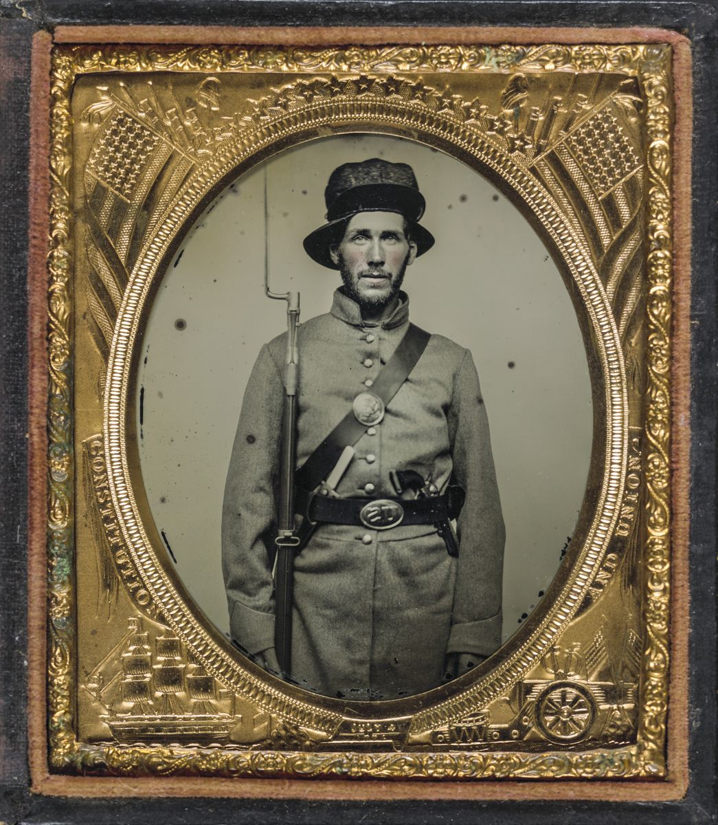Union soldier wearing frock coat and havelock/hat combination with bayoneted Model 1842 musket, knife, and Colt revolver. Liljenquist Family Collection of Civil War Photographs (Library of Congress).