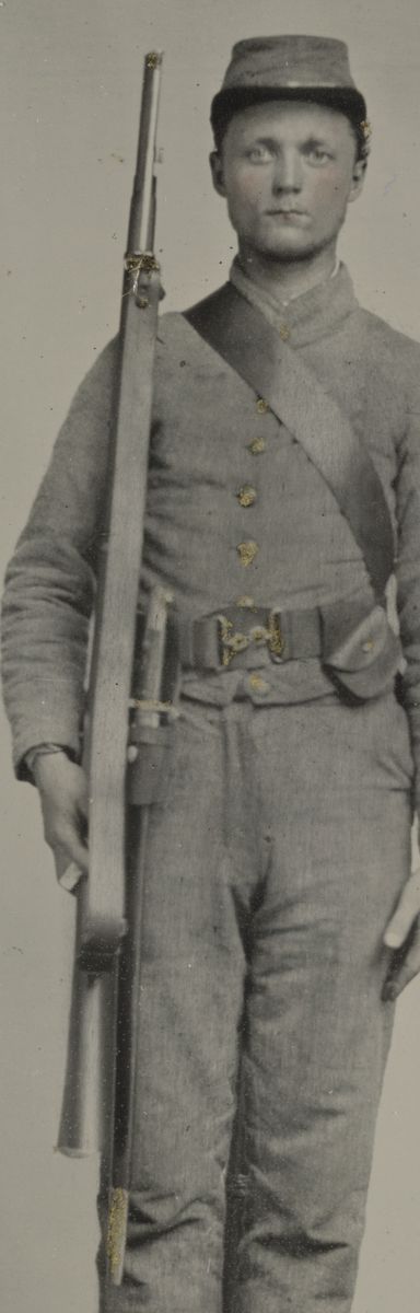 Enlargement of the photograph. Confederate solider holds an English imported Enfiled rifle and English accoutrements.