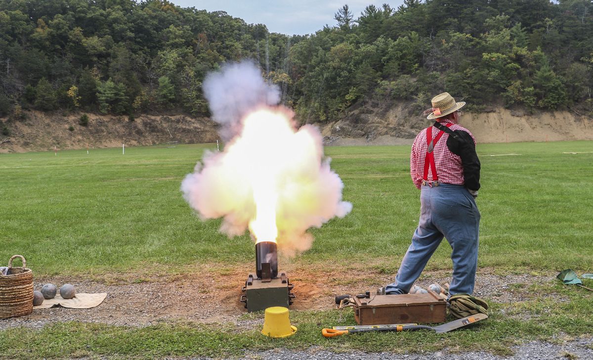 The firey muzzle blast from 3rd Maryland Artillery’s 12-pounder mortar makes it easy to see why the crewman firing the piece keeps a safe distance. Crews fire seven mortar balls at target stakes placed 100 yards from the firing line. The distances of the five closest shots are then tallied to determine a team’s score. (Niki Bethke)