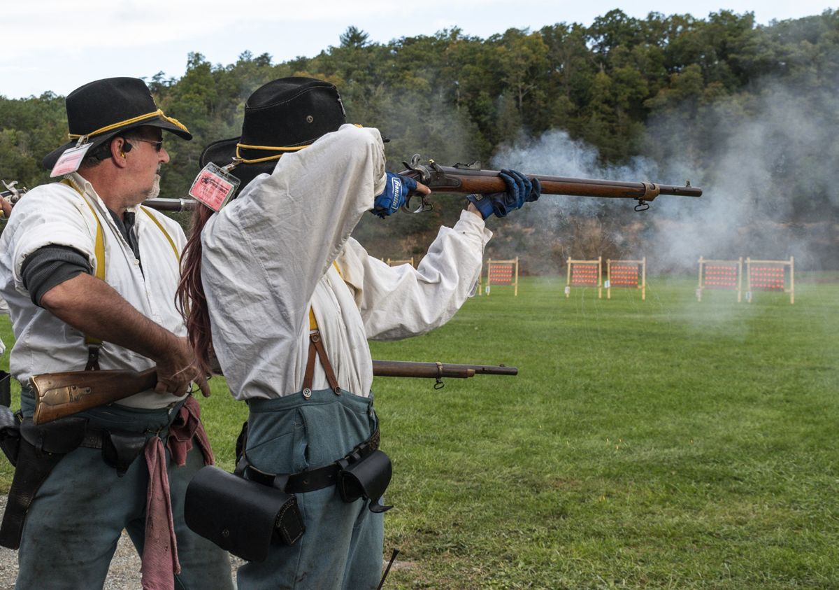 The 9th Regiment New York Cavalry starts firing in the first event of the rifled musket match. The eight-person musket teams compete to hit 32 clay pigeons to clear the board in the least amount of time. (Ericka Curley)