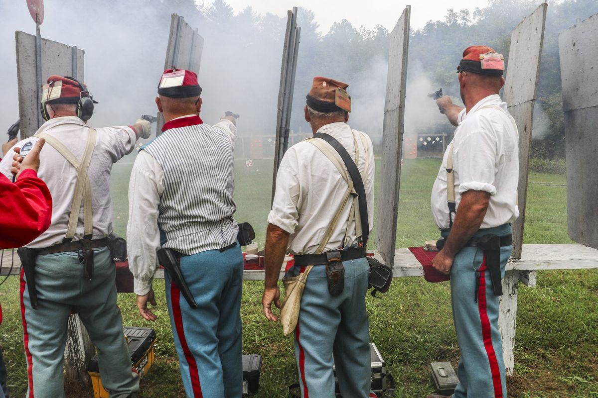 The 2nd Maryland, Baltimore Light Artillery, CSA revolver team fires at targets placed at 25 yards from the firing line. Muzzle blast and percussion cap fragments necessitate the dividers between each shooter. (Niki Bethke)