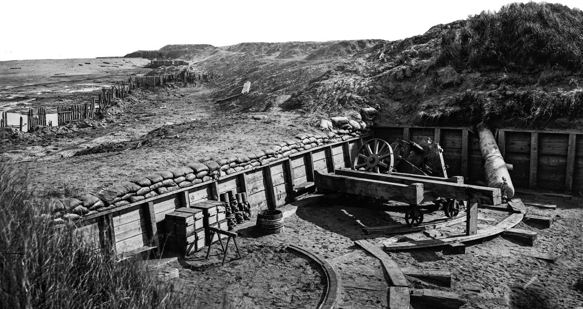 Fort Fisher, N.C. View of the land front, showing disabled cannon and destroyed gun carriage in second gun chamber. (Library of Congress)
