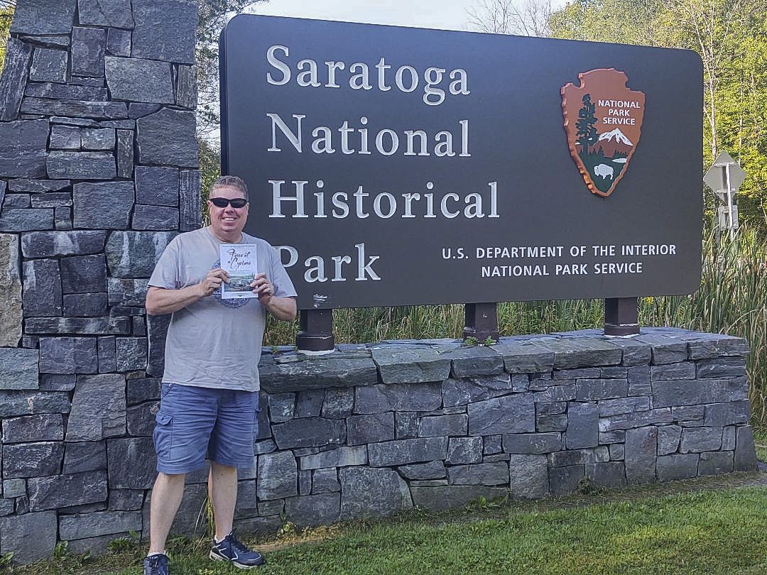 Bert Dunkerly poses with his new book at Saratoga Battlefield in New York.