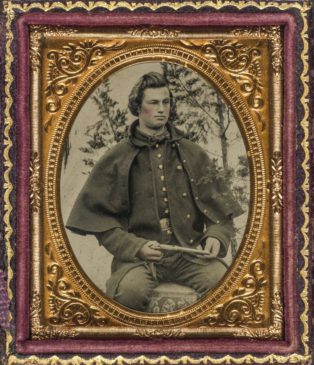 Union soldier in uniform wearing a greatcoat and holding a single shot handgun. (Liljenquist Family Collection of Civil War Photographs, Library of Congress)