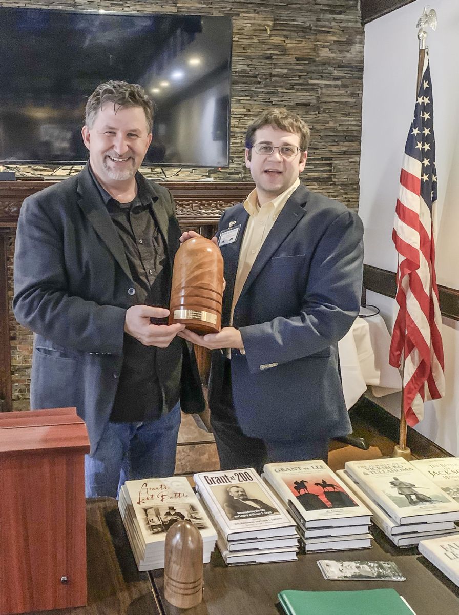 Chris Mackowski (left) accepts the award from Keith Altavilla.