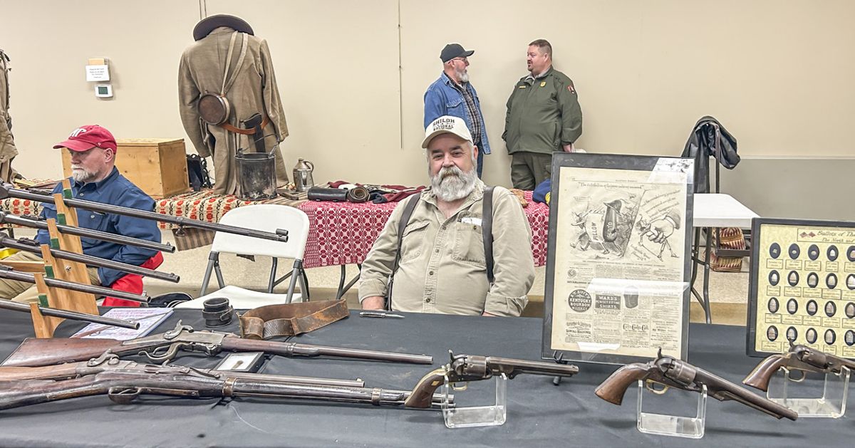 Greg Miller sits with his display of Civil War artifacts. This is the second year Greg has supported the event with his fine displays.