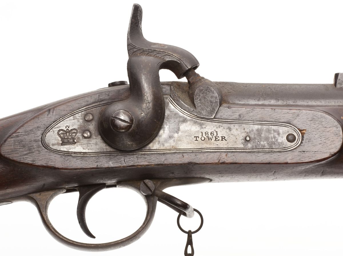 Lock plate showing the standard English crown behind the hammer and 1861/TOWER date in front of the hammer.