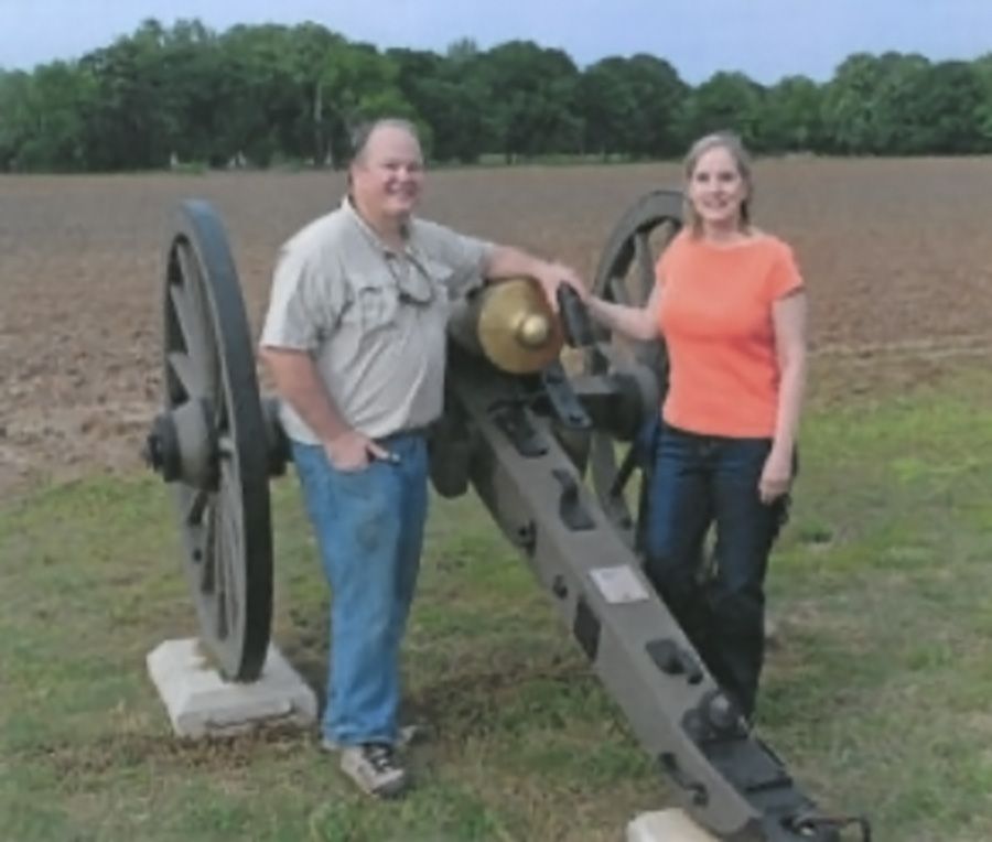 BGES members Ann and Bart Allen posing alongside the Texas Brigade cannon that they sponsored.