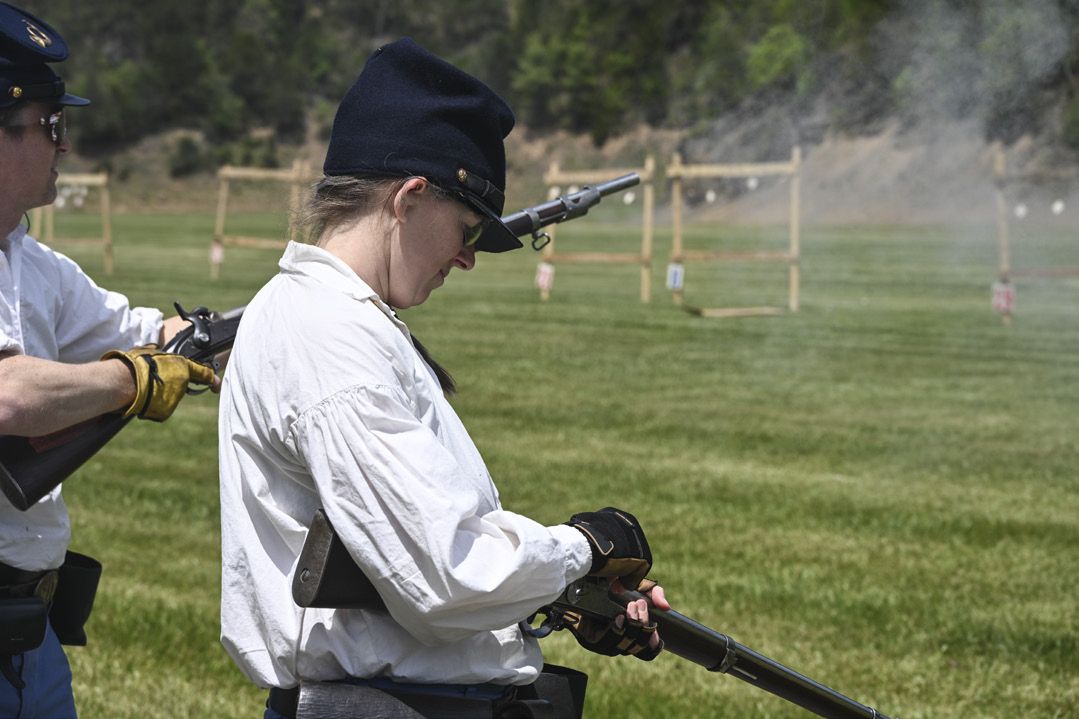 This young lady carefully caps her musket as she prepares to take aim at 4-inch by 4-inch ceramic tiles during the smoothbore musket match. Both men and women are ardent competitors in the N-SSA, but participants must be at least 14 years old.