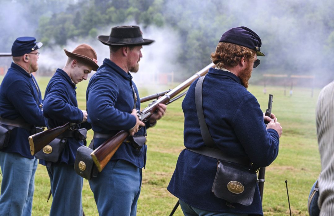Young members of the 1st Maryland Home Guard (U.S.) load and fire during the musket team match. One hundred thirty-nine teams participated in this match of speed and accuracy. (Lis Cole)
